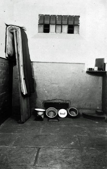 A First World War conscientious objector postcard depicting the interior of a cell at Wormwood Scrubs. © (IWM Q 103669)