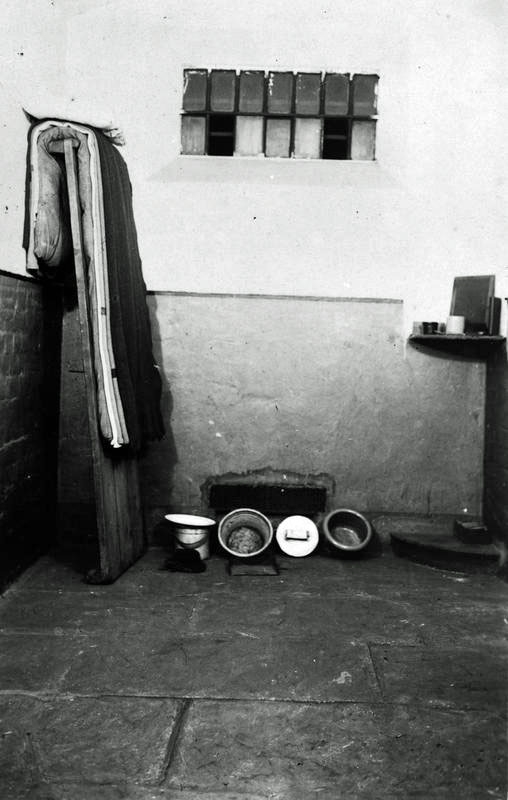 A First World War conscientious objector postcard depicting the interior of a cell at Wormwood Scrubs. © (IWM Q 103669)