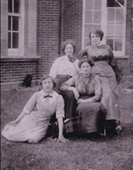 Annie (in grey dress kneeling) 