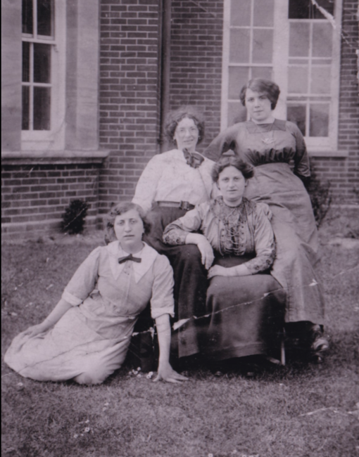 Annie (in grey dress kneeling) 
