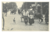 Man and Woman pulling their cart, with cow along side