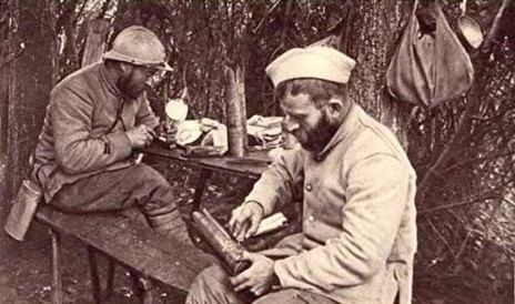 Soldiers creating art out of shell casings in the trenches
