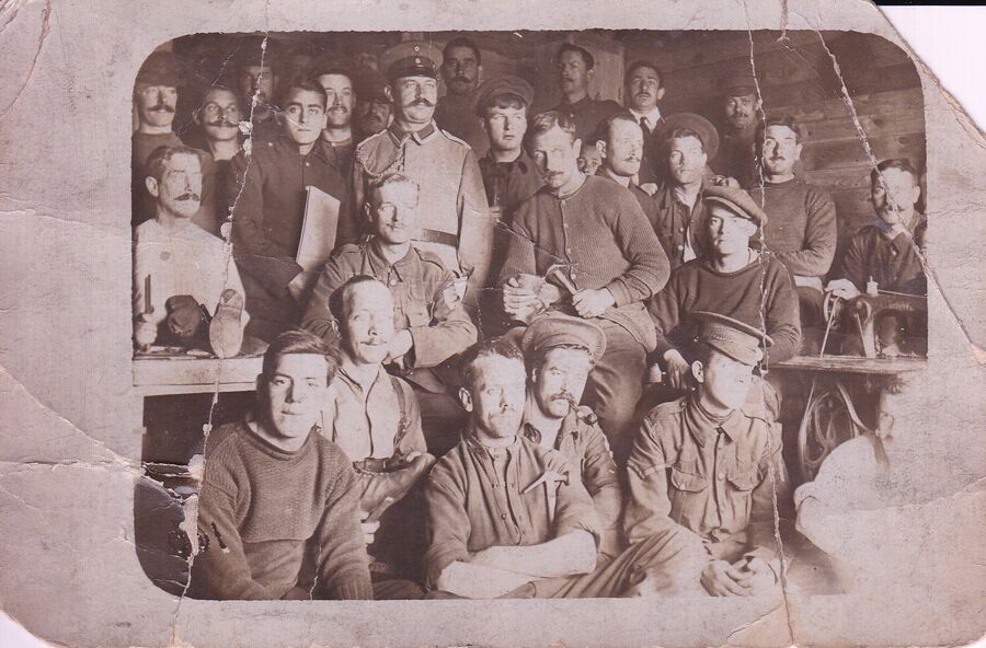 Prisoner of War camp, Meyer is second left, holding the book.