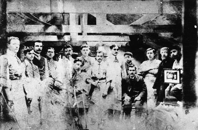 Photograph of a group of workmen in a cabinet making workshop in the East End of London. 1910.  ©Jewish Museum London