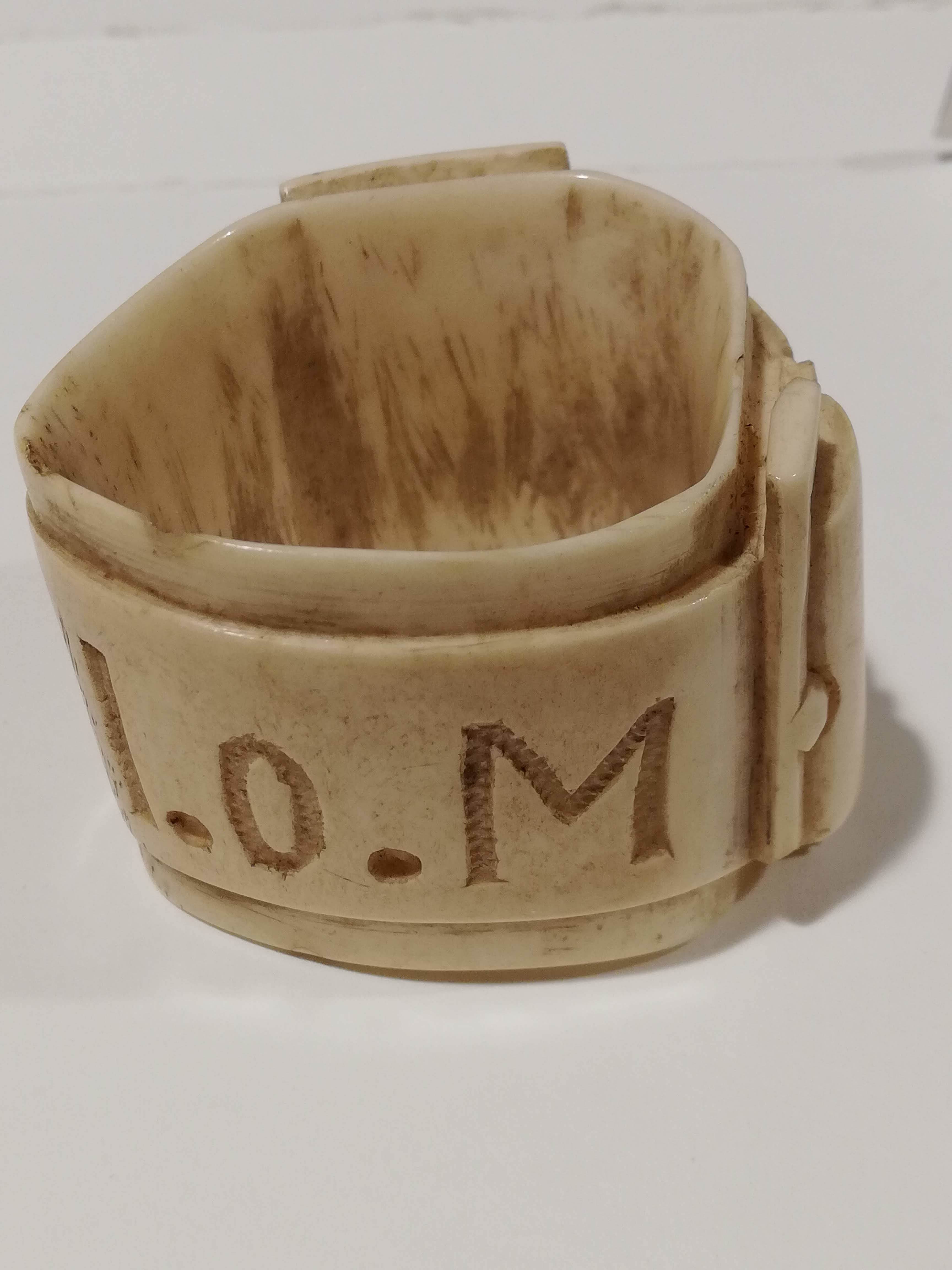 Bone napkin holder in belt design made in internment camp on Isle of Man (Manchester Jewish Museum)