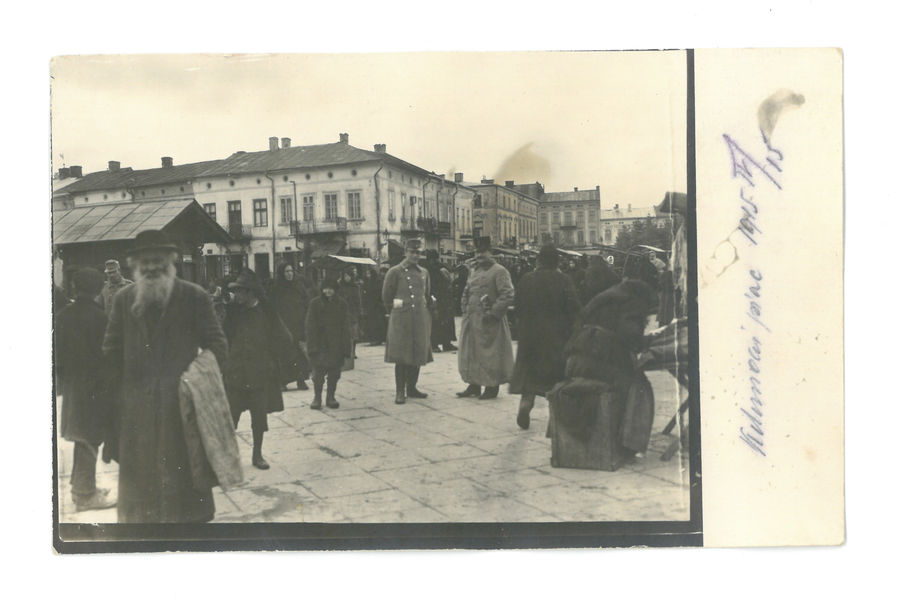 Two officers amid a group of Jews