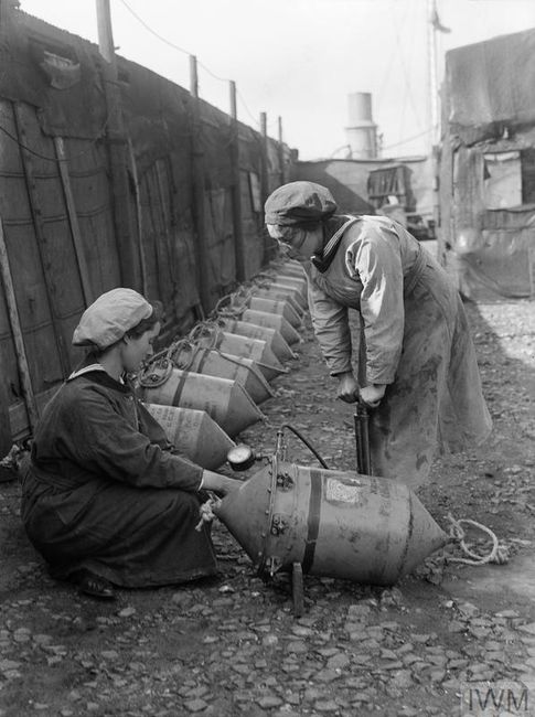 Two WRNS checking the air pressure in Electric Contact (EC) mines circa 1918. © IWM (Q 19648)