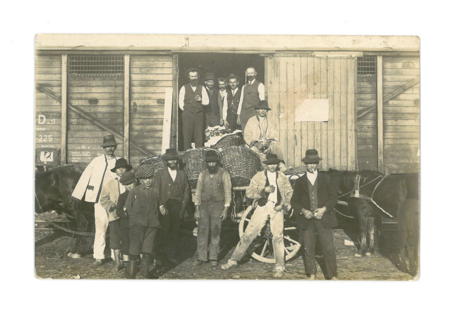 Group of men at a railway siding.
