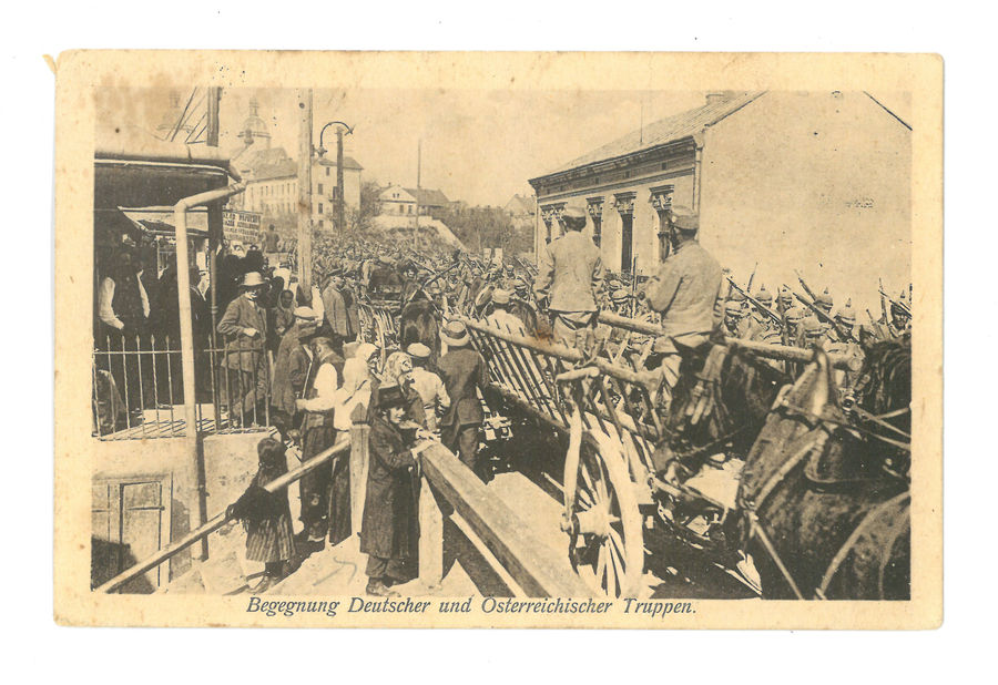 Jews watching marching soldiers.