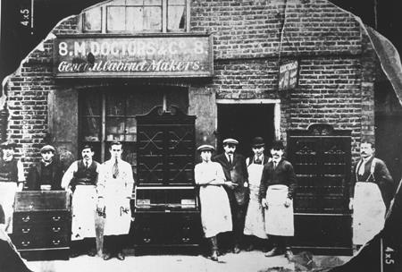 Mordechai Doctors, brother Asher and staff outside his cabinet-making workshop. Bethnal Green.1918. © Jewish Museum 461.1
