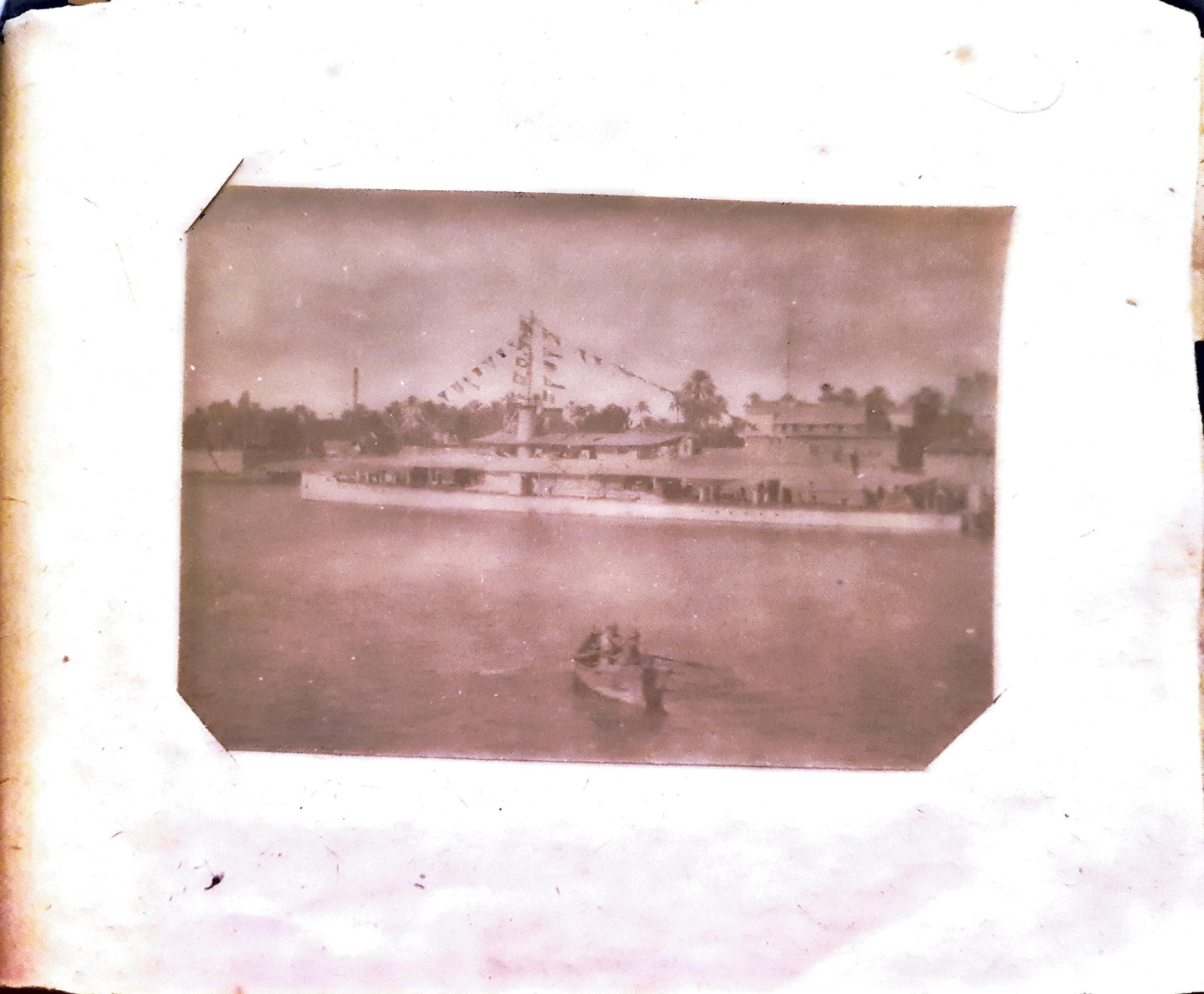 HMS Mantis (a large "China gunboat" first deployed to the Persian Gulf in 1916) outside G.H.Q - flags flying on the occasion of Armistice with Germany