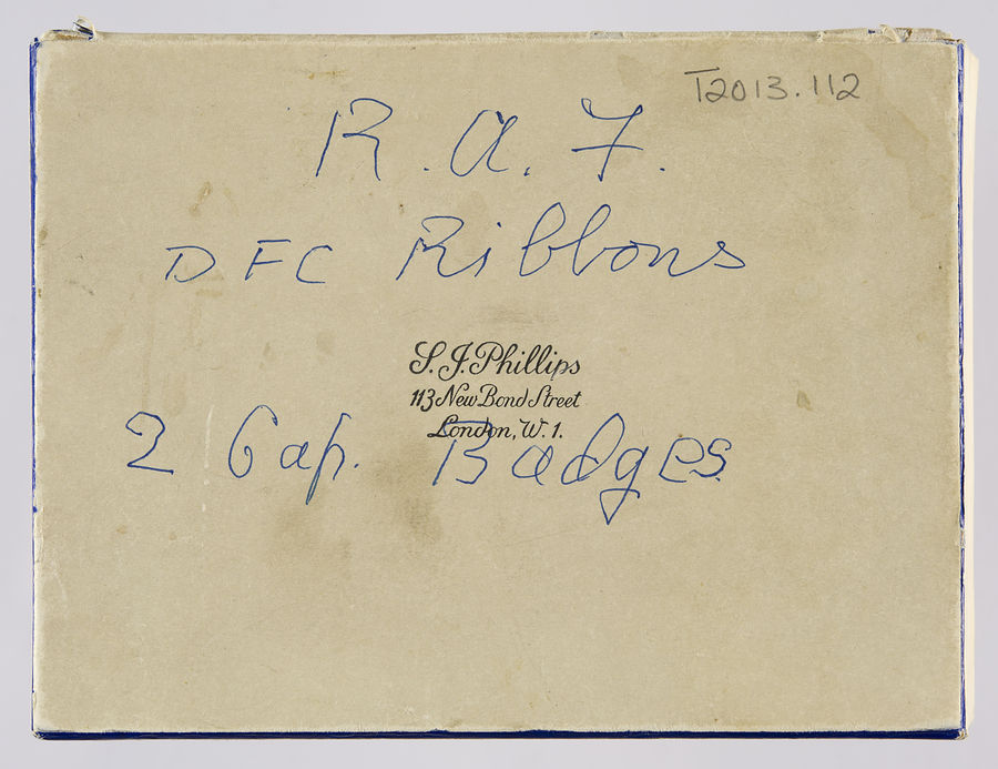 RAF Cap Band and Badge, RAF wings badge, Photograph of Alec Hyams, DFC Ribbon and four RAF uniform buttons. ©Jewish Museum London/Jewish Military Museum