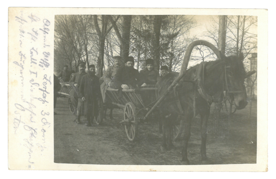 Group of civilians and soliders on horse cart